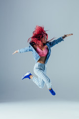 Young beautiful female dancer is posing in the studio