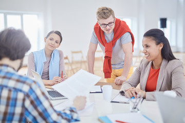 Group of young managers or economists gathered for start-up meeting in office