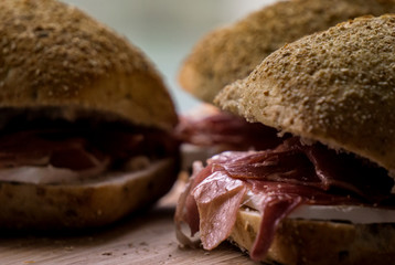 Close up of sandwich made with wholegrain bread, Parma ham and camembert cheese