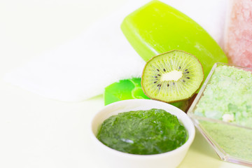 Aromatherapy spa concept. Orange sea salt, a bar of green soap, kiwi, closeup