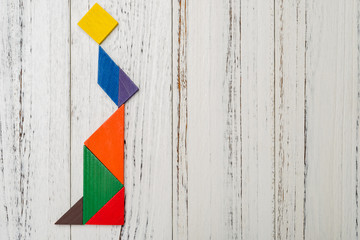 wooden tangram shaped like an elegant lady wears skirt with copy space