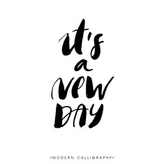 It's a new day. Modern brush calligraphy. Handwritten ink lettering. Hand drawn design elements.