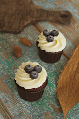 Homemade Sweet Cupcakes on a old wooden table.