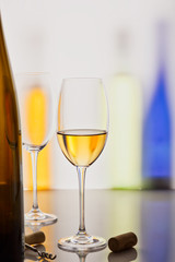 white wine in the glass. colored background