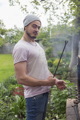 Man make barbeque near his country house