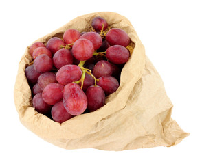 Fresh grapes in an environmentally friendly brown paper bag isolated on a white background