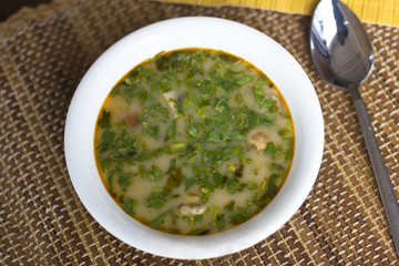 Spicy soup Tom Yam with shrimps and greens