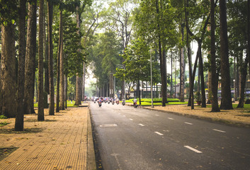 Street of Ho Chi Minh city, Vietnam. People riding bikes