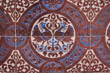 Close up of brown and blue drawings on tiles for pattern and background