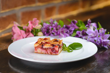 Elegant dessert, fruit pie, in the background flowers