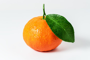 Mandarine or clementine with green leaf isolated on white background