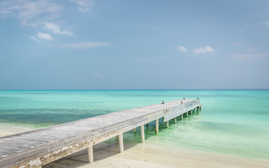 Fototapeta na wymiar Wooden jetty and beautiful ocean in Maldives