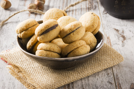 Baci di dama: delicious chocolate cookies with hazelnuts and topping