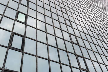 Glass surface of skyscrapers view in district of business centers with reflection on it, black and white