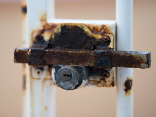 Rusty lock on the door dripping rain