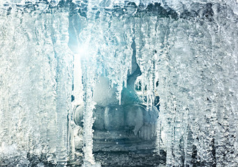 Frozen water in fountain with a rays of  light