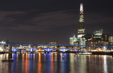 Beautiful landscape image of the London skyline at night looking along the River Thames
