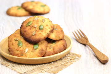 Sun flower seed cookies in a bowl on wooden background with copy space