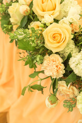 Simple but luxury rich table setting for a wedding celebration in nice cozy restaurant. Wineglasses, plates and bouquet of summer seasonal flowers on a table. Sunlight from a window. Copy space