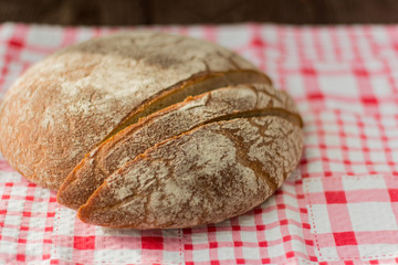 fresh rustic bread made of grey flour on the table