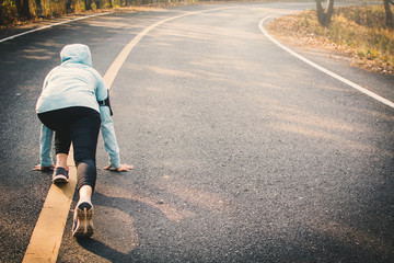 Woman running on the road for health, color of vintage tone selective and soft focus