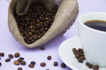 Coffee with sweets on light purple background