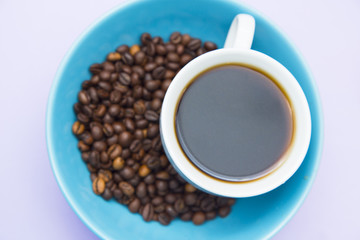 Coffee with sweets on light purple background
