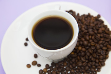 Coffee with sweets on light purple background