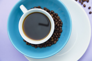 Coffee with sweets on light purple background
