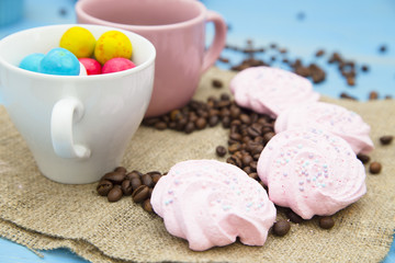 Coffee with sweets on a blue wooden background