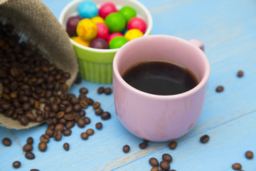 Coffee with sweets on a blue wooden background
