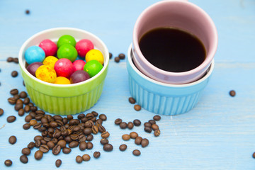 Coffee with sweets on a blue wooden background