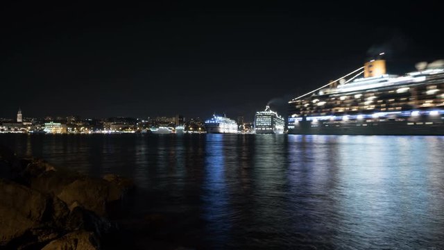 Night timelapse of cruise ships leaving the port