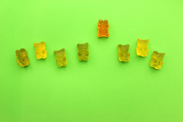 Gummy bears in different colors. Breaking stereotypes. Go out from the crowd starring Teddy bears. Concept babies. 