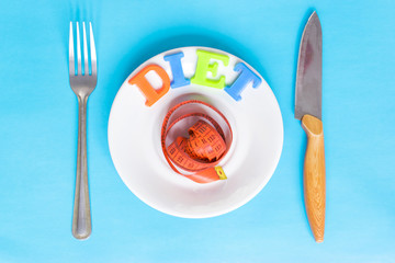 Word Diet made of colorful letters on a plate on the blue background.