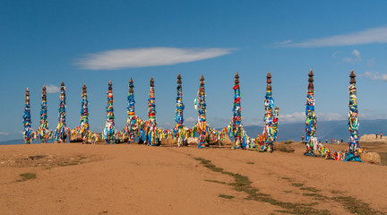 Sacred wooden columns with colourful ribbons, Baikal lake