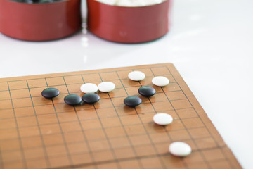 Obraz na płótnie Canvas Game's white and black stone on cross board.