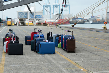 Suitcases of tourists of the sea liner at the unloading in the seaport