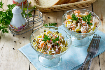 Easter recipe, festive snack. Salad with salmon, pickled cucumber, potatoes and capers - on the festive table.