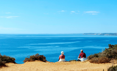 Fototapeta na wymiar Seniors enjoying the sun at the sea, Lagos, Algarve, Portugal