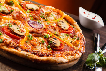 Pizza with salami, mushrooms and vegetables