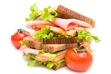 sandwiches with ham, saladf and tomatoes
