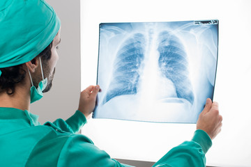 Surgeon looking at a lung radiography