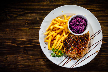 Grilled steak with french fries and vegetables 