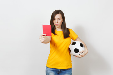 European serious severe young woman, football referee or player in yellow uniform showing red card,...