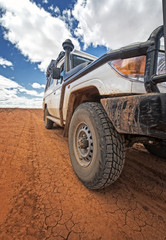 South Australia – Outback desert with 4WD on track under cloudy sky © HLPhoto