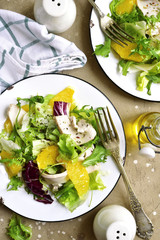 Detox salad from mix of salad leaves, chicken fillet and oranges.Top view with copy space.