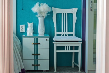 Interior 1. A chair, a vase, an owl. Bedroom in turquoise tones.