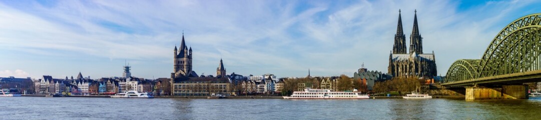Fototapeta premium Panorama of Cologne with Great St. Martin Church, Cologne Cathedral, Hohenzollern Bridge and the Rhine river, Germany