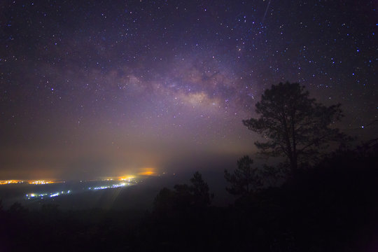 The Milky Way Galaxy and silhouette of trees in the mountains. Night scene landscape at Doi Dam view point Chiang mai, Thailand.